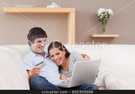 To use this stock image in your creative project, please select the size you need over to the right and click the "Add to Cart" button.
Your downloaded image will come with the Cutcaster watermark removed so don’t worry about the watermark you see on this page. Couple on the sofa shopping online stock photo, Young couple on the sofa shopping online by Wavebreak Media