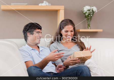 To use this stock image in your creative project, please select the size you need over to the right and click the "Add to Cart" button.
Your downloaded image will come with the Cutcaster watermark removed so don’t worry about the watermark you see on this page. Couple on the sofa with parcel stock photo, Young couple on the sofa with parcel by Wavebreak Media