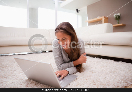 To use this stock image in your creative project, please select the size you need over to the right and click the "Add to Cart" button.
Your downloaded image will come with the Cutcaster watermark removed so don’t worry about the watermark you see on this page. Smiling woman lying with laptop on the floor stock photo, Smiling young woman lying with laptop on the floor by Wavebreak Media