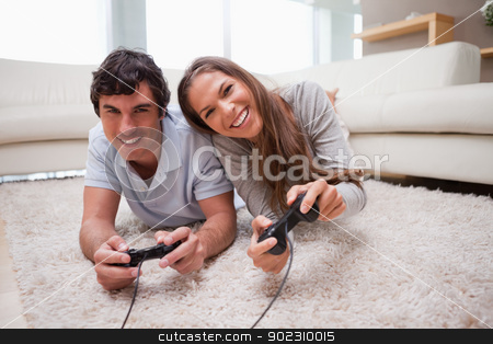 To use this stock image in your creative project, please select the size you need over to the right and click the "Add to Cart" button.
Your downloaded image will come with the Cutcaster watermark removed so don’t worry about the watermark you see on this page. Couple playing video games on the floor stock photo, Young couple playing video games on the floor by Wavebreak Media