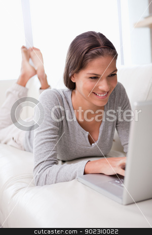 To use this stock image in your creative project, please select the size you need over to the right and click the "Add to Cart" button.
Your downloaded image will come with the Cutcaster watermark removed so don’t worry about the watermark you see on this page. Smiling woman lying on the sofa with her laptop stock photo, Smiling young woman lying on the sofa with her laptop by Wavebreak Media