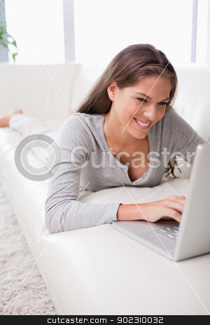 To use this stock image in your creative project, please select the size you need over to the right and click the "Add to Cart" button.
Your downloaded image will come with the Cutcaster watermark removed so don’t worry about the watermark you see on this page. Woman on the sofa typing on her notebook stock photo, Young woman on the sofa typing on her notebook by Wavebreak Media