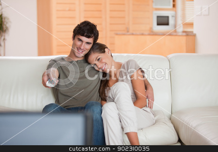 To use this stock image in your creative project, please select the size you need over to the right and click the "Add to Cart" button.
Your downloaded image will come with the Cutcaster watermark removed so don’t worry about the watermark you see on this page. Couple on the couch watching television together stock photo, Young couple on the couch watching television together by Wavebreak Media