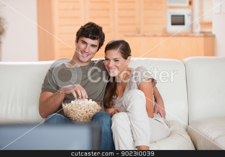 To use this stock image in your creative project, please select the size you need over to the right and click the "Add to Cart" button.
Your downloaded image will come with the Cutcaster watermark removed so don’t worry about the watermark you see on this page. Couple with popcorn on the sofa watching a movie stock photo, Young couple with popcorn on the sofa watching a movie by Wavebreak Media
