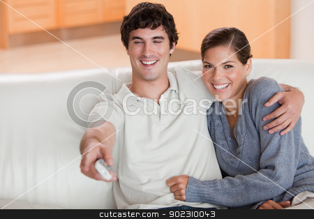 To use this stock image in your creative project, please select the size you need over to the right and click the "Add to Cart" button.
Your downloaded image will come with the Cutcaster watermark removed so don’t worry about the watermark you see on this page. Couple watching television on the couch stock photo, Young couple watching television on the couch by Wavebreak Media