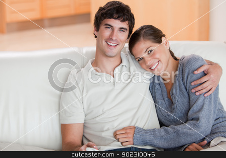 To use this stock image in your creative project, please select the size you need over to the right and click the "Add to Cart" button.
Your downloaded image will come with the Cutcaster watermark removed so don’t worry about the watermark you see on this page. Happy couple enjoying their time together on the couch stock photo, Happy young couple enjoying their time together on the couch by Wavebreak Media