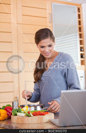 To use this stock image in your creative project, please select the size you need over to the right and click the "Add to Cart" button.
Your downloaded image will come with the Cutcaster watermark removed so don’t worry about the watermark you see on this page. Woman reading off a recipe while cooking stock photo, Young woman reading off a recipe while cooking by Wavebreak Media