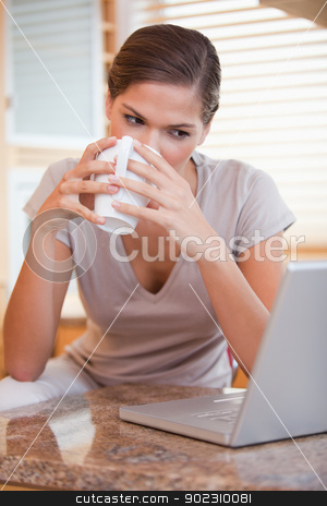To use this stock image in your creative project, please select the size you need over to the right and click the "Add to Cart" button.
Your downloaded image will come with the Cutcaster watermark removed so don’t worry about the watermark you see on this page. Woman taking a sip of coffee next to her laptop stock photo, Young woman taking a sip of coffee next to her laptop by Wavebreak Media