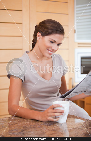 To use this stock image in your creative project, please select the size you need over to the right and click the "Add to Cart" button.
Your downloaded image will come with the Cutcaster watermark removed so don’t worry about the watermark you see on this page. Smiling woman reading newspaper in the kitchen stock photo, Smiling young woman reading newspaper in the kitchen by Wavebreak Media