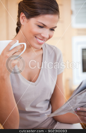 To use this stock image in your creative project, please select the size you need over to the right and click the "Add to Cart" button.
Your downloaded image will come with the Cutcaster watermark removed so don’t worry about the watermark you see on this page. Smiling woman reading newspaper while having tea stock photo, Smiling young woman reading newspaper while having tea by Wavebreak Media