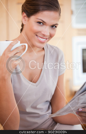 To use this stock image in your creative project, please select the size you need over to the right and click the "Add to Cart" button.
Your downloaded image will come with the Cutcaster watermark removed so don’t worry about the watermark you see on this page. Smiling woman reading the news while drinking coffee stock photo, Smiling young woman reading the news while drinking coffee by Wavebreak Media