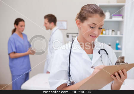 To use this stock image in your creative project, please select the size you need over to the right and click the "Add to Cart" button.
Your downloaded image will come with the Cutcaster watermark removed so don’t worry about the watermark you see on this page. Doctor with clipboard stock photo, Doctor with clipboard and colleagues behind her by Wavebreak Media