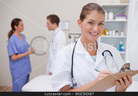 To use this stock image in your creative project, please select the size you need over to the right and click the "Add to Cart" button.
Your downloaded image will come with the Cutcaster watermark removed so don’t worry about the watermark you see on this page. Smiling doctor writing on clipboard stock photo, Smiling doctor writing on clipboard with colleagues behind her by Wavebreak Media
