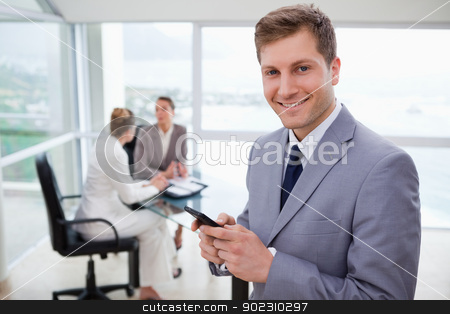 To use this stock image in your creative project, please select the size you need over to the right and click the "Add to Cart" button.
Your downloaded image will come with the Cutcaster watermark removed so don’t worry about the watermark you see on this page. Sales manager holding cellphone stock photo, Sales manager holding cellphone with his team sitting behind him by Wavebreak Media