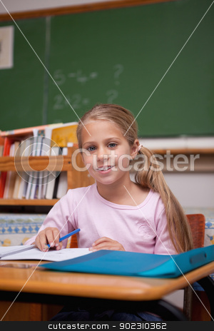 To use this stock image in your creative project, please select the size you need over to the right and click the "Add to Cart" button.
Your downloaded image will come with the Cutcaster watermark removed so don’t worry about the watermark you see on this page. Portrait of a cute schoolgirl writing stock photo, Portrait of a cute schoolgirl writing in a classroom by Wavebreak Media