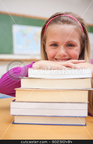 To use this stock image in your creative project, please select the size you need over to the right and click the "Add to Cart" button.
Your downloaded image will come with the Cutcaster watermark removed so don’t worry about the watermark you see on this page. Portrait of a smiling schoolgirl posing with a stack of books stock photo, Portrait of a smiling schoolgirl posing with a stack of books in a classroom by Wavebreak Media