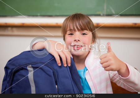 To use this stock image in your creative project, please select the size you need over to the right and click the "Add to Cart" button.
Your downloaded image will come with the Cutcaster watermark removed so don’t worry about the watermark you see on this page. Smiling schoolgirl posing with a bag and the thumb up stock photo, Smiling schoolgirl posing with a bag and the thumb up in a classroom by Wavebreak Media