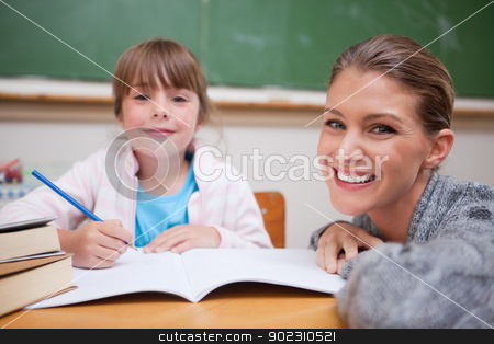 To use this stock image in your creative project, please select the size you need over to the right and click the "Add to Cart" button.
Your downloaded image will come with the Cutcaster watermark removed so don’t worry about the watermark you see on this page. Schoolgirl writing with her teacher stock photo, Schoolgirl writing with her teacher in a classroom by Wavebreak Media