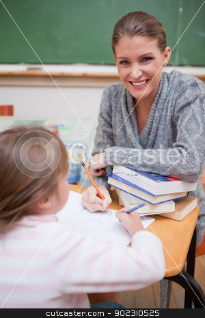 To use this stock image in your creative project, please select the size you need over to the right and click the "Add to Cart" button.
Your downloaded image will come with the Cutcaster watermark removed so don’t worry about the watermark you see on this page. Portrait of a teacher explaining something to her pupil stock photo, Portrait of a teacher explaining something to her pupil in a classroom by Wavebreak Media