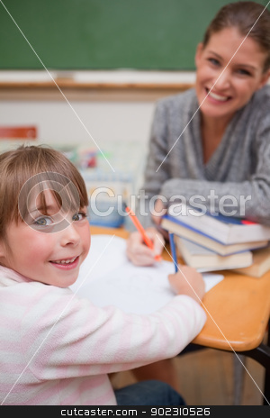 To use this stock image in your creative project, please select the size you need over to the right and click the "Add to Cart" button.
Your downloaded image will come with the Cutcaster watermark removed so don’t worry about the watermark you see on this page. Portrait of a smiling teacher explaining something to her pupil stock photo, Portrait of a smiling teacher explaining something to her pupil in a classroom by Wavebreak Media