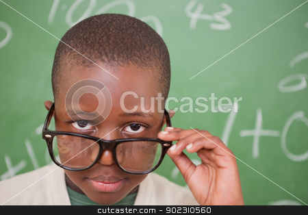 To use this stock image in your creative project, please select the size you need over to the right and click the "Add to Cart" button.
Your downloaded image will come with the Cutcaster watermark removed so don’t worry about the watermark you see on this page. Schoolboy looking over his glasses stock photo, Schoolboy looking over his glasses in front of a blackboard by Wavebreak Media