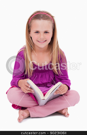 To use this stock image in your creative project, please select the size you need over to the right and click the "Add to Cart" button.
Your downloaded image will come with the Cutcaster watermark removed so don’t worry about the watermark you see on this page. Portrait of a happy girl reading a book stock photo, Portrait of a happy girl reading a book against a white background by Wavebreak Media