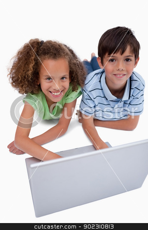 To use this stock image in your creative project, please select the size you need over to the right and click the "Add to Cart" button.
Your downloaded image will come with the Cutcaster watermark removed so don’t worry about the watermark you see on this page. Portrait of children using a notebook while lying on the floor stock photo, Portrait of children using a notebook while lying on the floor against a white background by Wavebreak Media