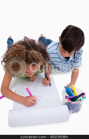 To use this stock image in your creative project, please select the size you need over to the right and click the "Add to Cart" button.
Your downloaded image will come with the Cutcaster watermark removed so don’t worry about the watermark you see on this page. Portrait of children drawing while lying on the floor stock photo, Portrait of children drawing while lying on the floor against a white background by Wavebreak Media
