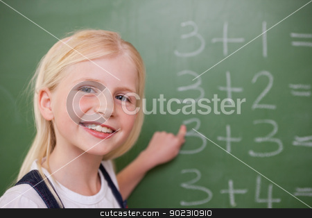 To use this stock image in your creative project, please select the size you need over to the right and click the "Add to Cart" button.
Your downloaded image will come with the Cutcaster watermark removed so don’t worry about the watermark you see on this page. Blonde schoolgirl pointing at something stock photo, Blonde schoolgirl pointing at something on a blackboard by Wavebreak Media