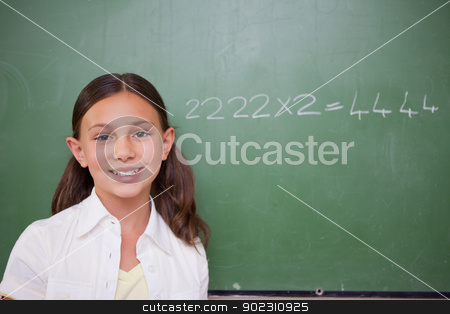 To use this stock image in your creative project, please select the size you need over to the right and click the "Add to Cart" button.
Your downloaded image will come with the Cutcaster watermark removed so don’t worry about the watermark you see on this page. Schoolgirl posing in front of a chalkboard stock photo, Schoolgirl posing in front of a chalkboard in a classroom by Wavebreak Media