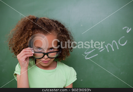 To use this stock image in your creative project, please select the size you need over to the right and click the "Add to Cart" button.
Your downloaded image will come with the Cutcaster watermark removed so don’t worry about the watermark you see on this page. Schoolgirl looking above her glasses stock photo, Schoolgirl looking above her glasses in front of a blackboard by Wavebreak Media