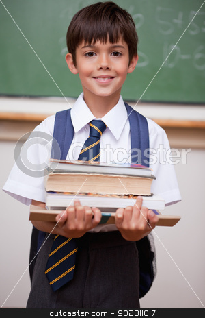 To use this stock image in your creative project, please select the size you need over to the right and click the "Add to Cart" button.
Your downloaded image will come with the Cutcaster watermark removed so don’t worry about the watermark you see on this page. Portrait of a schoolboy holding books stock photo, Portrait of a schoolboy holding books in a classroom by Wavebreak Media