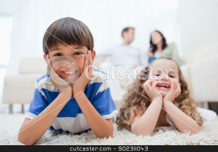 To use this stock image in your creative project, please select the size you need over to the right and click the "Add to Cart" button.
Your downloaded image will come with the Cutcaster watermark removed so don’t worry about the watermark you see on this page. Kids lying on the carpet with parents sitting behind them stock photo, Young kids with lying on the carpet with parents sitting behind them by Wavebreak Media