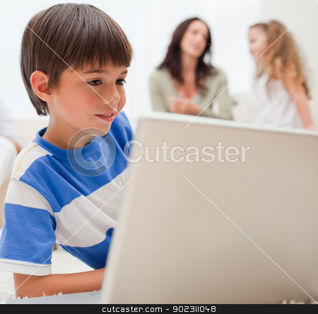 To use this stock image in your creative project, please select the size you need over to the right and click the "Add to Cart" button.
Your downloaded image will come with the Cutcaster watermark removed so don’t worry about the watermark you see on this page. Boy playing computer games with his family behind him stock photo, Young boy playing computer games with his family behind him by Wavebreak Media