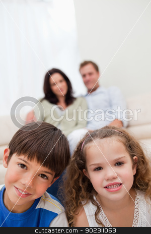 To use this stock image in your creative project, please select the size you need over to the right and click the "Add to Cart" button.
Your downloaded image will come with the Cutcaster watermark removed so don’t worry about the watermark you see on this page. Children sitting in the living room with parents behind them stock photo, Children sitting in the living room with their parents behind them by Wavebreak Media