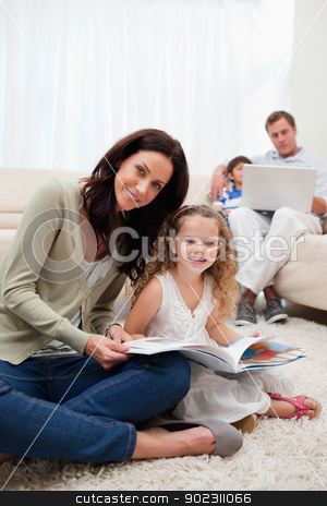To use this stock image in your creative project, please select the size you need over to the right and click the "Add to Cart" button.
Your downloaded image will come with the Cutcaster watermark removed so don’t worry about the watermark you see on this page. Mother and daughter reading book together stock photo, Mother and daughter reading book in together in the living room by Wavebreak Media