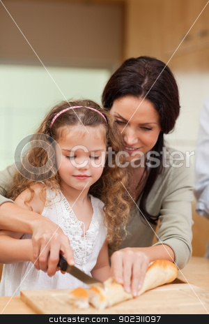 To use this stock image in your creative project, please select the size you need over to the right and click the "Add to Cart" button.
Your downloaded image will come with the Cutcaster watermark removed so don’t worry about the watermark you see on this page. Mother and daughter cutting bread into slices stock photo, Mother and daughter cutting bread into slices together by Wavebreak Media