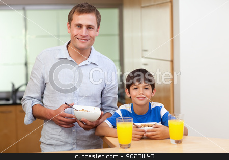 To use this stock image in your creative project, please select the size you need over to the right and click the "Add to Cart" button.
Your downloaded image will come with the Cutcaster watermark removed so don’t worry about the watermark you see on this page. Father and son having cereals and orange juice stock photo, Father and son having cereals and orange juice together by Wavebreak Media