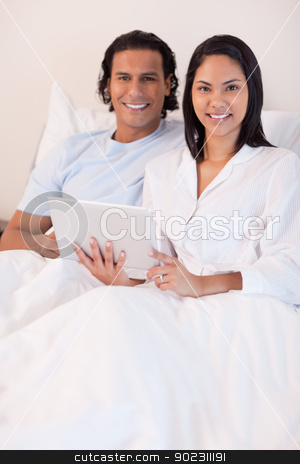 To use this stock image in your creative project, please select the size you need over to the right and click the "Add to Cart" button.
Your downloaded image will come with the Cutcaster watermark removed so don’t worry about the watermark you see on this page. Couple using tablet pc in their bed stock photo, Young couple using tablet pc in their bed by Wavebreak Media