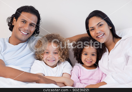 To use this stock image in your creative project, please select the size you need over to the right and click the "Add to Cart" button.
Your downloaded image will come with the Cutcaster watermark removed so don’t worry about the watermark you see on this page. Smiling family sitting on the bed together stock photo, Happy smiling family sitting on the bed together by Wavebreak Media