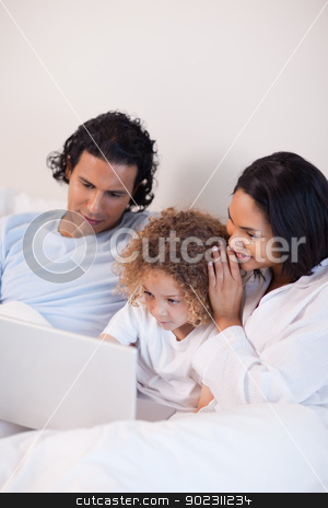 To use this stock image in your creative project, please select the size you need over to the right and click the "Add to Cart" button.
Your downloaded image will come with the Cutcaster watermark removed so don’t worry about the watermark you see on this page. Family sitting on the bed with laptop stock photo, Young family sitting on the bed with laptop by Wavebreak Media