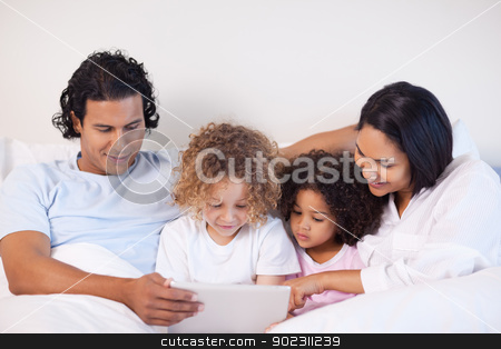 To use this stock image in your creative project, please select the size you need over to the right and click the "Add to Cart" button.
Your downloaded image will come with the Cutcaster watermark removed so don’t worry about the watermark you see on this page. Family sitting on the bed surfing the web stock photo, Young family sitting on the bed surfing the web by Wavebreak Media