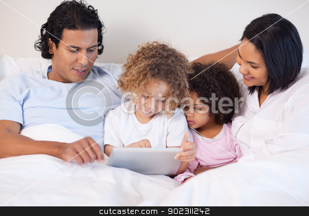 To use this stock image in your creative project, please select the size you need over to the right and click the "Add to Cart" button.
Your downloaded image will come with the Cutcaster watermark removed so don’t worry about the watermark you see on this page. Family sitting on the bed using tablet stock photo, Young family sitting on the bed using tablet by Wavebreak Media