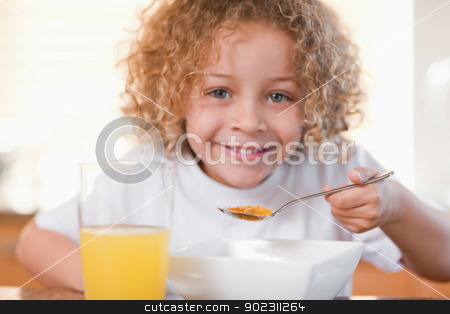 To use this stock image in your creative project, please select the size you need over to the right and click the "Add to Cart" button.
Your downloaded image will come with the Cutcaster watermark removed so don’t worry about the watermark you see on this page. Smiling girl having breakfast in the kitchen stock photo, Smiling young girl having breakfast in the kitchen by Wavebreak Media