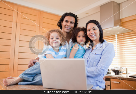 To use this stock image in your creative project, please select the size you need over to the right and click the "Add to Cart" button.
Your downloaded image will come with the Cutcaster watermark removed so don’t worry about the watermark you see on this page. Happy family with laptop standing in the kitchen together stock photo, Happy young family with laptop standing in the kitchen together by Wavebreak Media