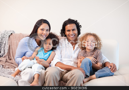 To use this stock image in your creative project, please select the size you need over to the right and click the "Add to Cart" button.
Your downloaded image will come with the Cutcaster watermark removed so don’t worry about the watermark you see on this page. Cheerful family sitting on the sofa together stock photo, Cheerful young family sitting on the sofa together by Wavebreak Media