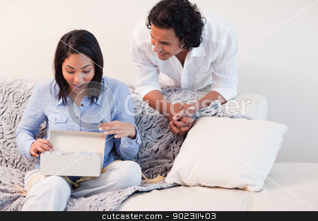 To use this stock image in your creative project, please select the size you need over to the right and click the "Add to Cart" button.
Your downloaded image will come with the Cutcaster watermark removed so don’t worry about the watermark you see on this page. Woman opening the present she got from her boyfriend stock photo, Young woman opening the present she got from her boyfriend by Wavebreak Media