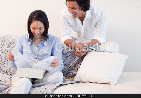 To use this stock image in your creative project, please select the size you need over to the right and click the "Add to Cart" button.
Your downloaded image will come with the Cutcaster watermark removed so don’t worry about the watermark you see on this page. Woman opening the gift she got from her boyfriend stock photo, Young woman opening the gift she got from her boyfriend by Wavebreak Media