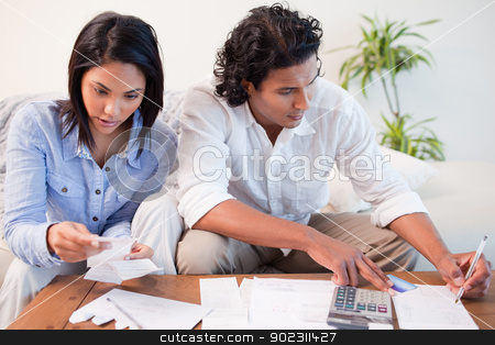 To use this stock image in your creative project, please select the size you need over to the right and click the "Add to Cart" button.
Your downloaded image will come with the Cutcaster watermark removed so don’t worry about the watermark you see on this page. Couple checking bills in the living room stock photo, Young room checking bills in the living room by Wavebreak Media