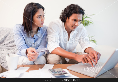 To use this stock image in your creative project, please select the size you need over to the right and click the "Add to Cart" button.
Your downloaded image will come with the Cutcaster watermark removed so don’t worry about the watermark you see on this page. Couple checking their bank accounts online stock photo, Young couple checking their bank accounts online by Wavebreak Media